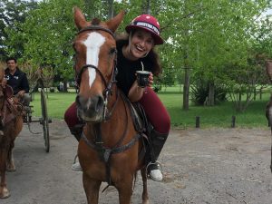 girl on a horse drinking mate at estancia in Argentina