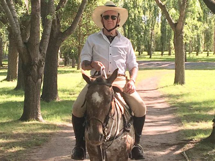 man riding a horse at estancia in Argentina