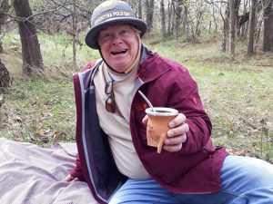 man smiling and holding a mate at estancia in argentina