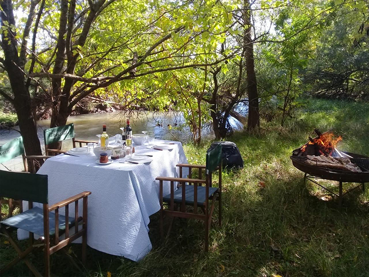 table set for lunch by the lake at estancia in argentina